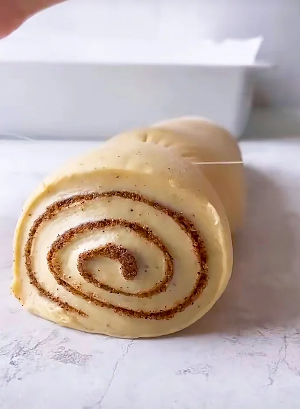 cutting cinnamon roll