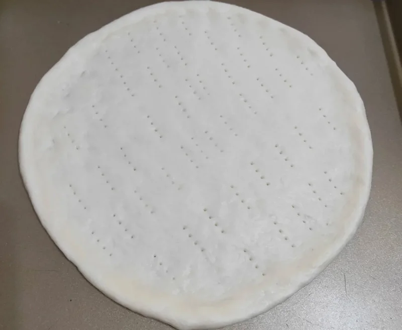 pizza dough poking holes
