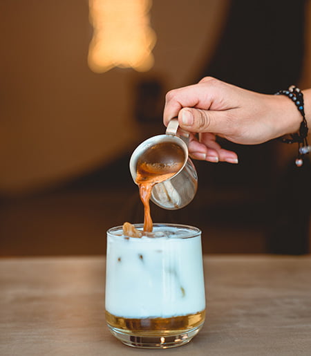 Person making iced coffee Person making iced coffee