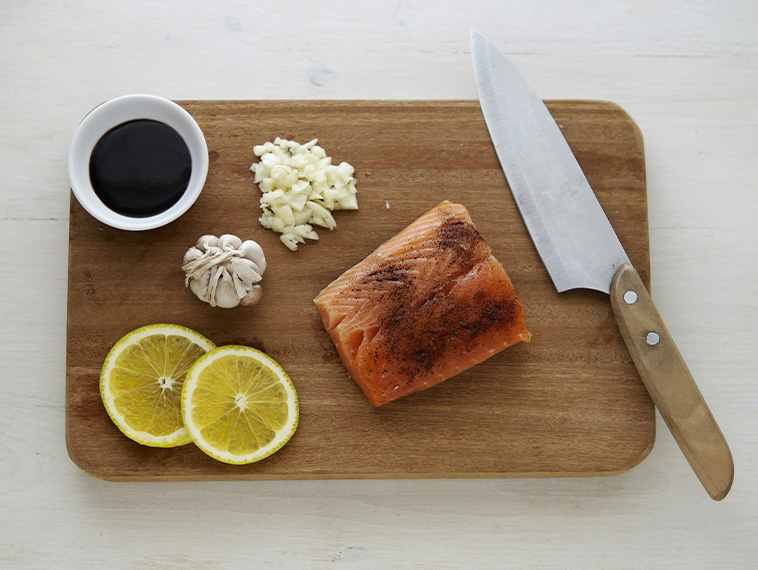 Knife and ingredients on chopping board