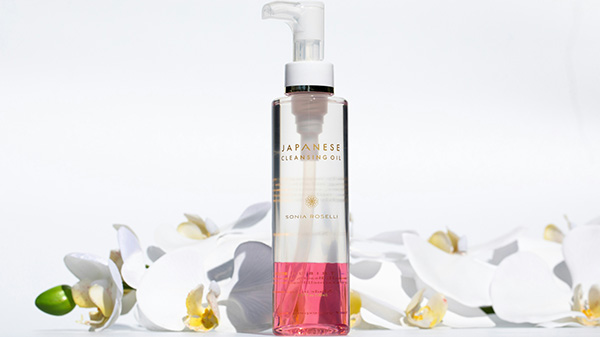 Bottle of Japanese cleansing oil with white orchids