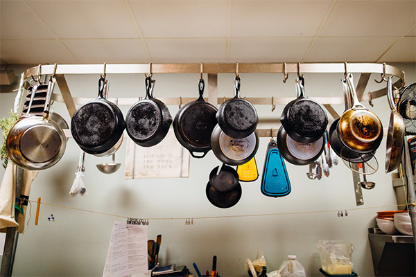 Different cookwares hanging on a rack